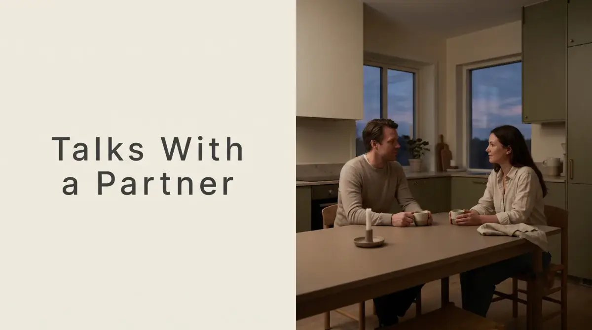 two people talking gently across a kitchen table at dusk