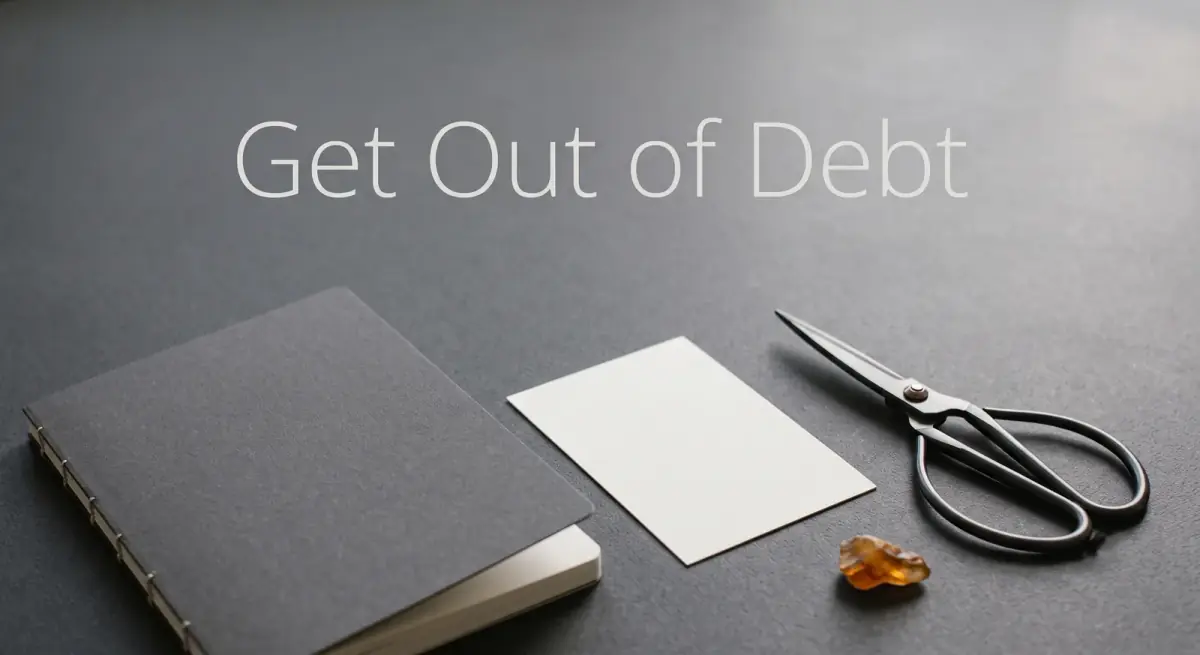 a pair of scissors resting beside a plain unbranded card on a tidy desk with a notebook