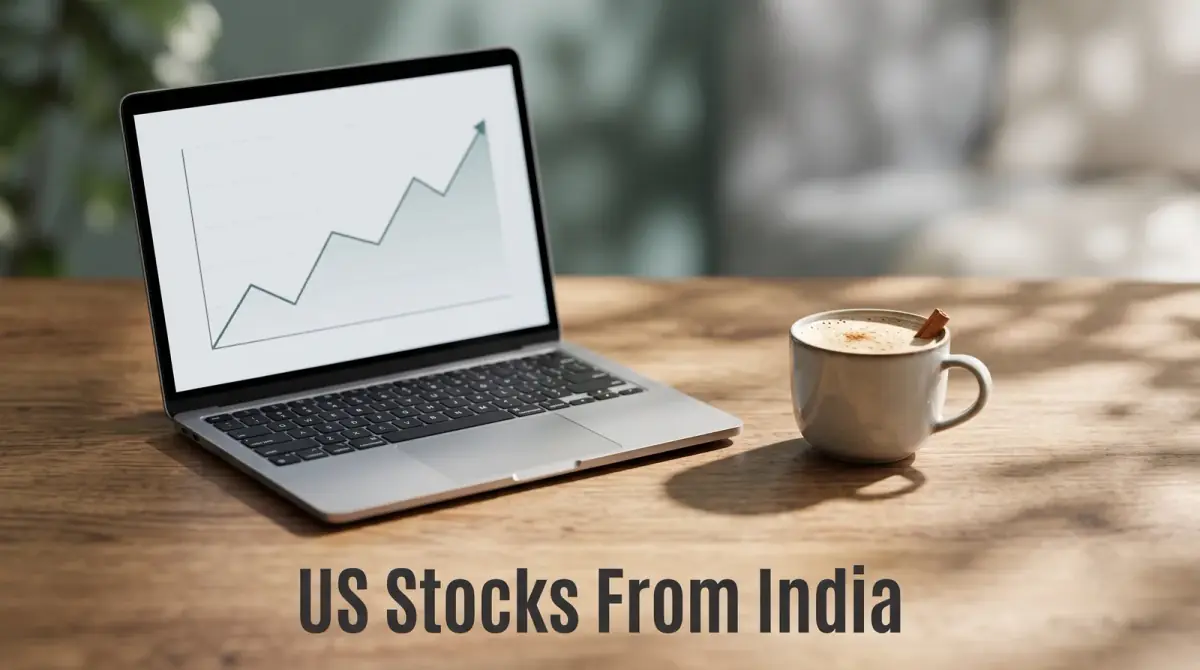 a laptop showing a simple line chart beside a cup of chai on a warm wooden desk