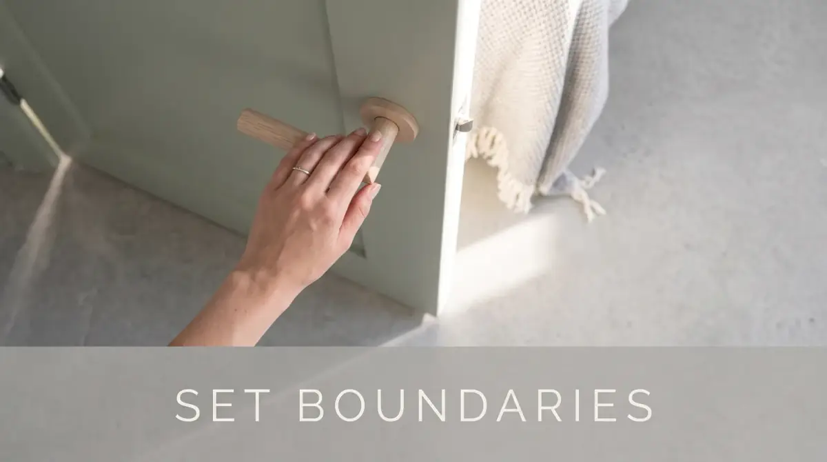 a hand gently closing a door partway, letting a soft band of light through
