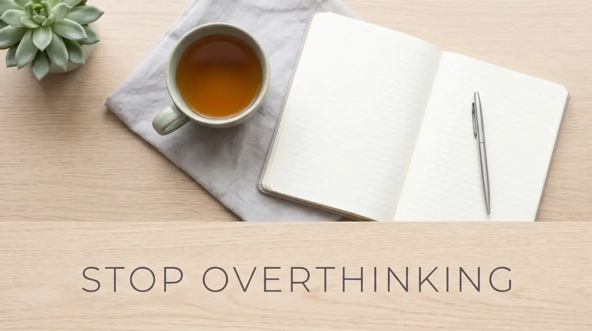 a calm morning table with a single cup of tea and an open blank notebook